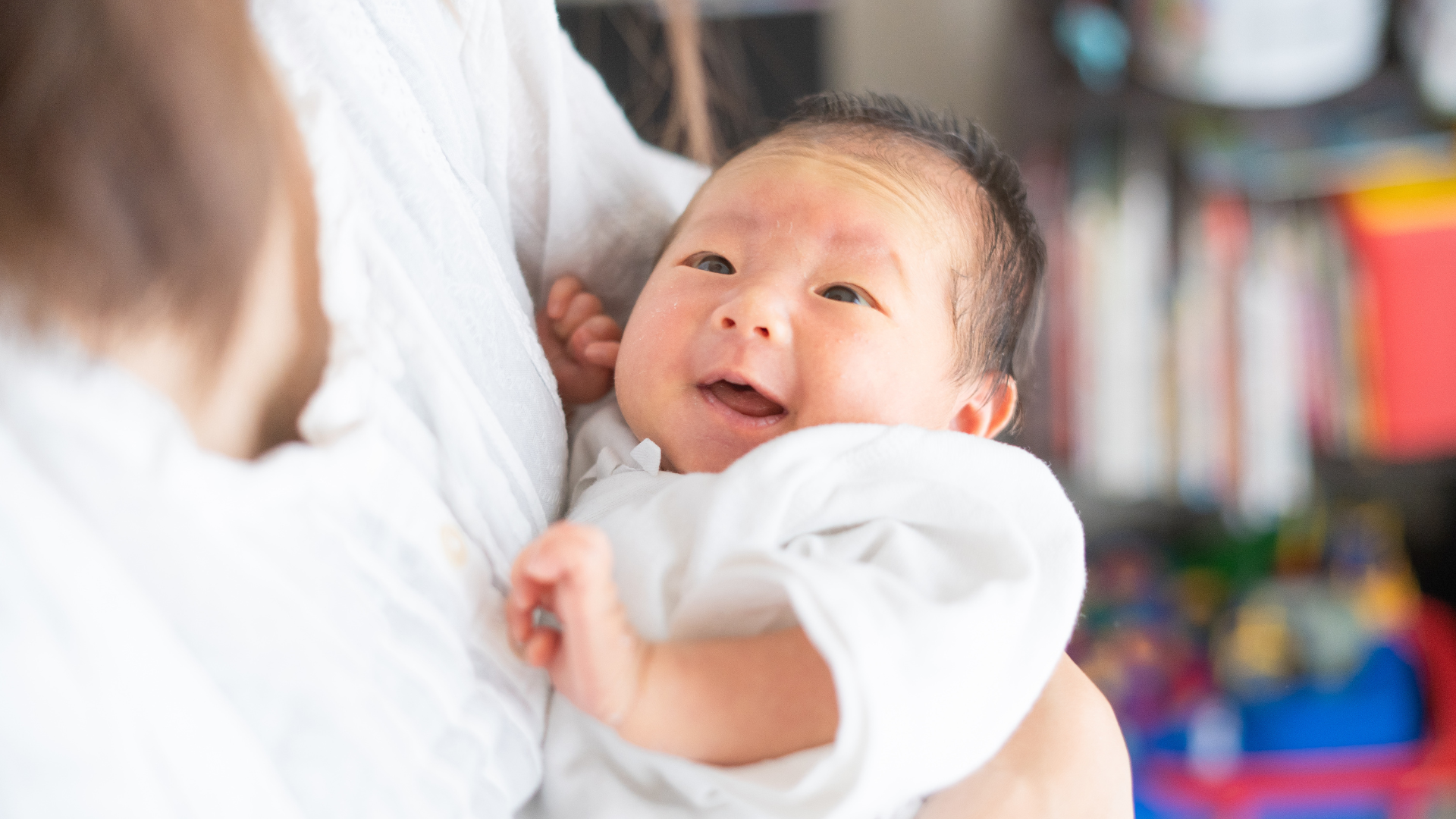 Moms receiving WIC benefits breastfeeds her newborn baby at home